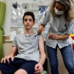 A teenager receives a dose of a vaccine against the coronavirus disease (COVID-19) in Tel Aviv